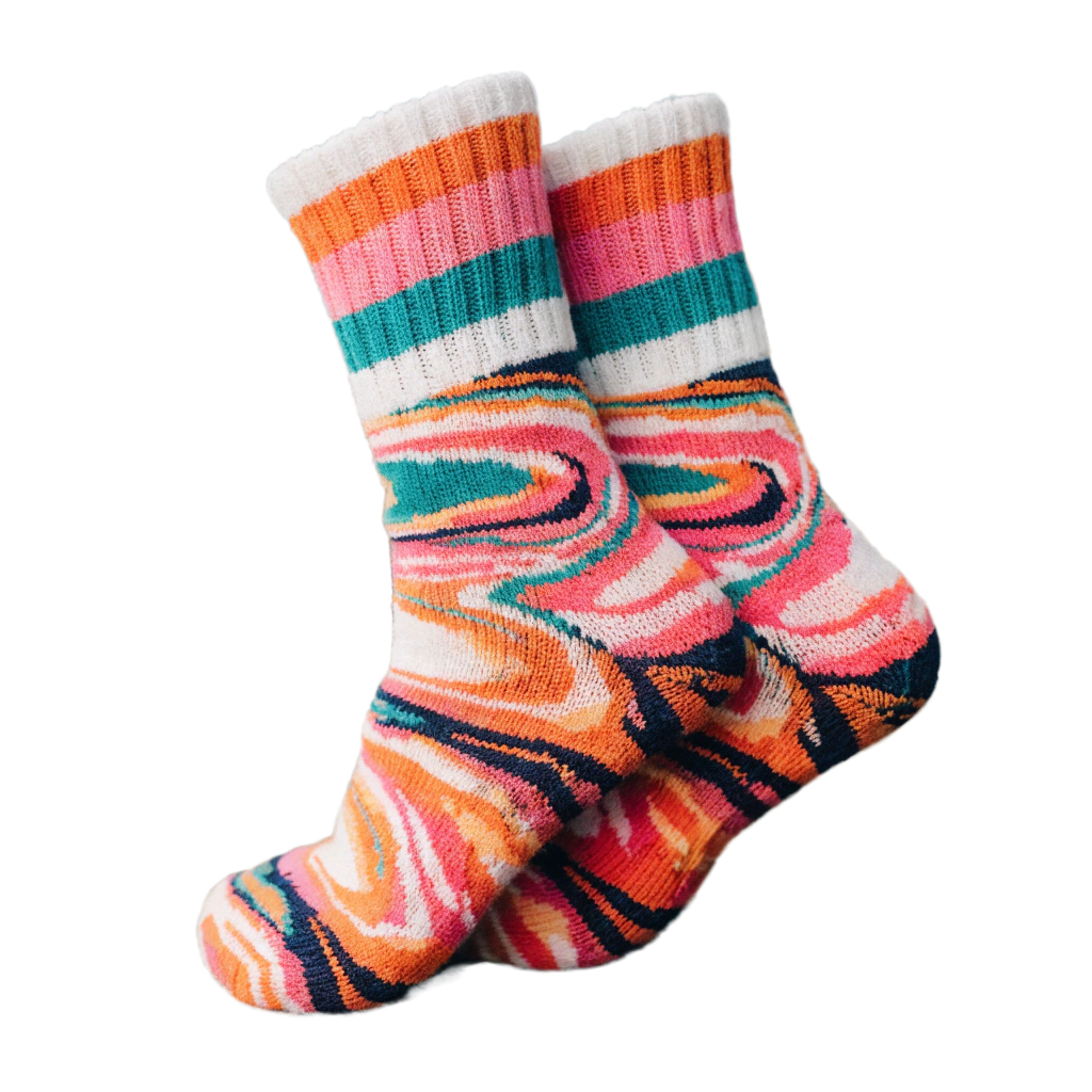 Pair of colorful crew socks with abstract swirl pattern in orange, pink, and teal tones isolated on black